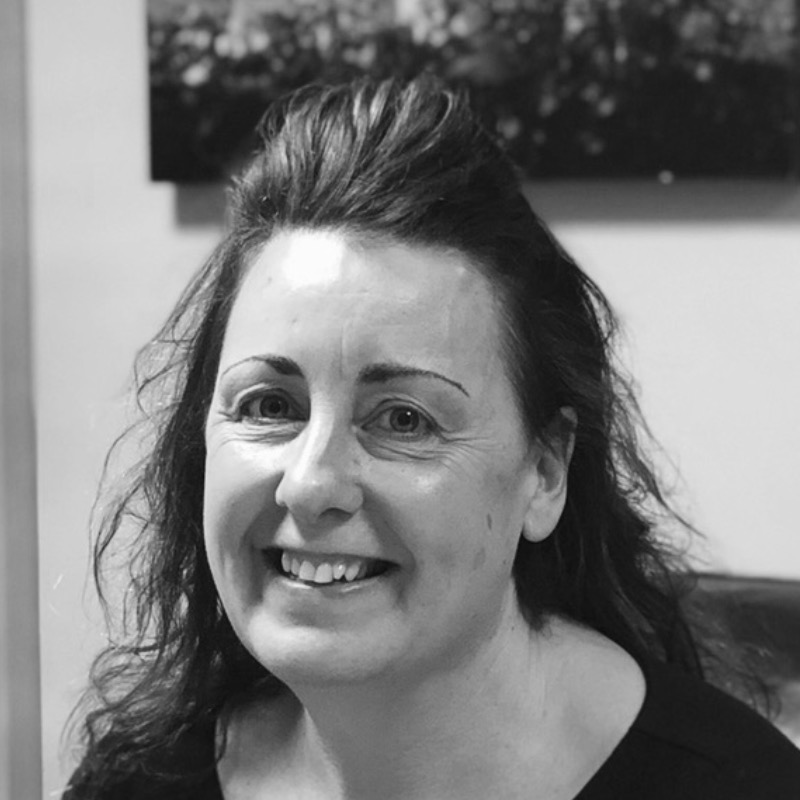 Jane Tillings smiling in a black and white portrait